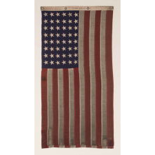 48 STAR, U.S. NAVY SMALL BOAT ENSIGN, MADE AT MARE ISLAND, CALIFORNIA [HEADQUARTERS OF THE PACIFIC FLEET] DURING WWII, SIGNED AND DATED JULY 1942, WITH EXTENSIVE WEAR FROM OBVIOUS USE