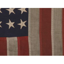 48 STAR, U.S. NAVY SMALL BOAT ENSIGN, MADE AT MARE ISLAND, CALIFORNIA [HEADQUARTERS OF THE PACIFIC FLEET] DURING WWII, SIGNED AND DATED JULY 1942, WITH EXTENSIVE WEAR FROM OBVIOUS USE