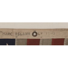 48 STAR, U.S. NAVY SMALL BOAT ENSIGN, MADE AT MARE ISLAND, CALIFORNIA [HEADQUARTERS OF THE PACIFIC FLEET] DURING WWII, SIGNED AND DATED JULY 1942, WITH EXTENSIVE WEAR FROM OBVIOUS USE