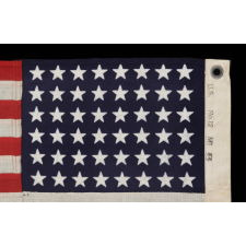 48 STAR, U.S. NAVY SMALL BOAT ENSIGN, MADE AT MARE ISLAND, CALIFORNIA DURING WWII, SIGNED AND DATED 1944, IN THE SMALLEST SCALE EMPLOYED AT THE TIME