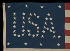 48 STARS CONFIGURED INTO THE LETTERS "U.S.A.", COPYWRITTEN IN 1916 BY C.A. HARTMAN, ONE OF ONLY THREE KNOWN SURVIVING EXAMPLES AND ONE OF THE MOST INTERESTING DESIGNS KNOWN TO EXIST IN EARLY FLAGS