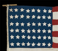 48 STARS, AN ELONGATED HOMEMADE FLAG WITH CRUDE FOLK FEATURES, FOUND IN BRITAIN, LIKELY MADE IN FRANCE OR BELGIUM, FLOWING LIBERATION FROM THE GERMANS DURING WWII (1941-45)