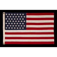 49 STAR AMERICAN FLAG IN A SMALL SCALE AMONG ITS COUNTERPARTS WITH PIECED AND SEWN CONSTRUCTION, REFLECTS THE ADDITION OF ALASKA IN 1959, OFFICIAL FOR JUST ONE YEAR; EXHIBITED JUNE-SEPTEMBER, 2021 AT THE MUSEUM OF THE AMERICAN REVOLUTION