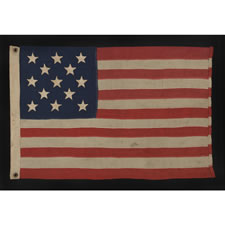 ANTIQUE AMERICAN FLAG WITH 13 HAND-SEWN STARS IN A 3-2-3-2-3 CONFIGURATION, IN AN EXTREMELY SCARCE, SMALL SIZE FOR THE PERIOD, 1876 CENTENNIAL ERA