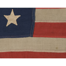 ANTIQUE AMERICAN FLAG WITH 13 HAND-SEWN STARS IN A 3-2-3-2-3 CONFIGURATION, IN AN EXTREMELY SCARCE, SMALL SIZE FOR THE PERIOD, 1876 CENTENNIAL ERA