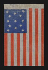 ANTIQUE AMERICAN FLAG WITH 13 STARS IN A MEDALLION CONFIGURATION, CHROMATIC BLUE & ORANGE , A RARE EXAMPLE, OPENING YEARS OF THE CIVIL WAR (1861-63)