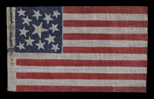 ANTIQUE AMERICAN FLAG WITH 13 STARS, MADE IN THE CIVIL WAR - CENTENNIAL ERA (1861-1876), WITH THREE SIZES OF FOLKY STARS IN A MEDALLION PATTERN