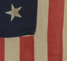 ANTIQUE AMERICAN FLAG WITH 13 STARS, A U.S. NAVY SMALL BOAT ENSIGN WITH AN EXTREMELY RARE BLOCK-PRINTED MARK FROM THE BOSTON NAVY YARD, 1863-1866