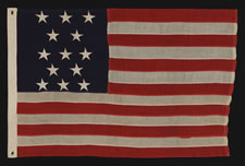 ANTIQUE AMERICAN FLAG WITH 13 STARS IN A 3-2-3-2-3 PATTERN, ARRANGED IN A HIGHLY UNUSUAL VERTICAL COLUMN;  A SMALL-SCALE EXAMPLE OF THE 1895-1910 ERA