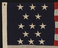 ANTIQUE AMERICAN FLAG WITH 13 STARS IN A 3-2-3-2-3 PATTERN, ARRANGED IN A HIGHLY UNUSUAL VERTICAL COLUMN;  A SMALL-SCALE EXAMPLE OF THE 1895-1910 ERA