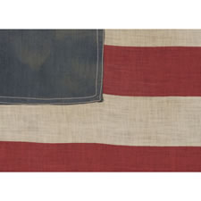 ANTIQUE AMERICAN FLAG WITH 13 STARS IN THE BETSY ROSS PATTERN, A HOMEMADE, MAKE-DO EXAMPLE OF THE 1926-1945 ERA