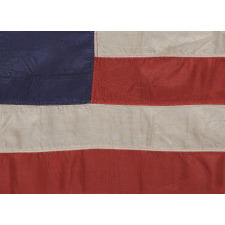 BEAUTIFULLY GRAPHIC AND HIGHLY UNORDINARY 13 STAR FLAG IN THE BETSY ROSS PATTERN, A MADE OF FINE SILK WITH SILK FRINGE AND TIES, IN A TINY SIZE AMONG ITS COUNTERPARTS CA 1895-1926