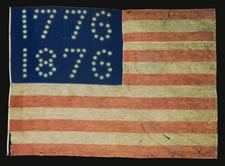 CENTENNIAL EXPOSITION PARADE FLAG WITH 10-POINTED STARS THAT SPELL "1776 - 1876", ONE OF THE MOST GRAPHIC OF ALL EARLY EXAMPLES, EX-RICHARD PIERCE COLLECTION