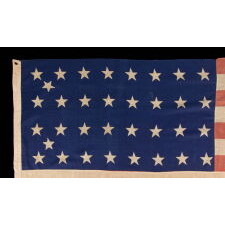 34 STAR ANTIQUE AMERICAN FLAG OF THE CIVIL WAR PERIOD (1861-63), WITH WOVEN STRIPES, PRESS-DYED STARS, AND BEAUTIFUL COLORS, POSSIBLY MADE IN NEW YORK BY THE ANNIN COMPANY, REFLECTS THE ADDITION OF KANSAS TO THE UNION, 1861-1863