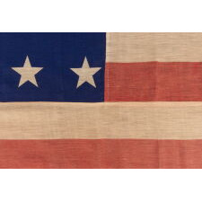 34 STAR ANTIQUE AMERICAN FLAG OF THE CIVIL WAR PERIOD (1861-63), WITH WOVEN STRIPES, PRESS-DYED STARS, AND BEAUTIFUL COLORS, POSSIBLY MADE IN NEW YORK BY THE ANNIN COMPANY, REFLECTS THE ADDITION OF KANSAS TO THE UNION, 1861-1863