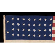 34 STARS IN 4 ROWS WITH 2 STARS OFFSET AT THE HOIST END, ON AN ANTIQUE AMERICAN FLAG LIKELY PRODUCED FOR MILITARY FUNCTION, AS UNION ARMY CAMP COLORS; ONE OF JUST A TINY HANDFUL THAT I HAVE ENCOUNTERED IN THIS EXACT STYLE, REFLECTS KANSAS STATEHOOD, OPENING TWO YEARS OF THE CIVIL WAR, 1861-1863