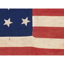 34 STARS IN 4 ROWS WITH 2 STARS OFFSET AT THE HOIST END, ON AN ANTIQUE AMERICAN FLAG LIKELY PRODUCED FOR MILITARY FUNCTION, AS UNION ARMY CAMP COLORS; ONE OF JUST A TINY HANDFUL THAT I HAVE ENCOUNTERED IN THIS EXACT STYLE, REFLECTS KANSAS STATEHOOD, OPENING TWO YEARS OF THE CIVIL WAR, 1861-1863