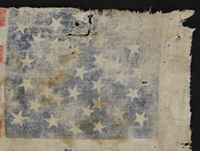 CIVIL WAR PERIOD CAMPAIGN PARADE FLAG MADE FOR THE 1864 PRESIDENTIAL RUN OF ABRAHAM LINCOLN & ANDREW JOHNSON, WITH ENDEARING WEAR FROM OBVIOUS LONG-TERM USE, 34 STARS IN A GREAT-STAR-IN-A-WREATH PATTERN, ONE-OF-A-KIND AMONG KNOWN EXAMPLES