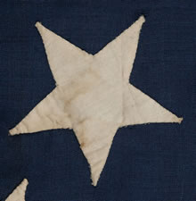 CONFEDERATE 1ST NATIONAL (STARS & BARS) PATTERN FLAG, POSSIBLY A NAVAL ENSIGN, WITH 13 LARGE STARS IN A WHIMSICAL WREATH, ENTIRELY HAND-SEWN, 1861-63