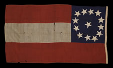 CONFEDERATE 1ST NATIONAL (STARS & BARS) PATTERN FLAG, POSSIBLY A NAVAL ENSIGN, WITH 13 LARGE STARS IN A WHIMSICAL WREATH, ENTIRELY HAND-SEWN, 1861-63