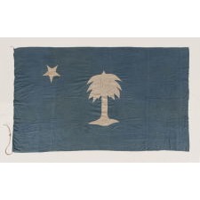 THE EARLIEST SOUTH CAROLINA PALMETTO FLAG IN PRIVATE HANDS, MADE CA 1830-60, WITH BEAUTIFUL COLOR AND A LONE STAR IN PLACE OF A CRESCENT, HANDED DOWN THROUGH THE FAMILY OF GENERAL PHILIP D. COOK (b. 1804, d. 1872) OF THE SOUTH CAROLINA MILITIA, WHO MUSTERED INTO THE HOLCOMB LEGION OF CHARLESTON AND SERVED IN CONFEDERATE CAVALRY COMPANY B (CONGAREE CAVALIERS); FOUND IN A SLIDE-LID WALNUT BOX ACCOMPANIED BY COOK’S MILITIA EPAULETS, RIDING BOOTS, AND COCKADE WITH A CADET BUTTON FROM THE CITADEL