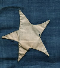 EARLY 13 STAR SHIP'S FLAG WITH A LOPSIDED OVAL VARIATION OF THE 3RD MARYLAND PATTERN, CA 1840-1860, ENTIRELY HAND-SEWN, A BEAUTIFUL EXAMPLE