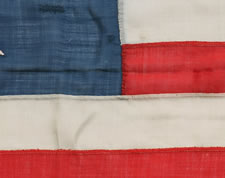 EARLY 13 STAR SHIP'S FLAG WITH A LOPSIDED OVAL VARIATION OF THE 3RD MARYLAND PATTERN, CA 1840-1860, ENTIRELY HAND-SEWN, A BEAUTIFUL EXAMPLE