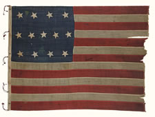 ENTIRELY HAND-SEWN, 13 STAR FLAG IN THE 4-5-4 PATTERN, PROBABLY A U.S. NAVY SMALL BOAT ENSIGN, MADE SOMETIME BETWEEN 1850 AND THE OPENING YEARS OF THE CIVIL WAR (1861-63)