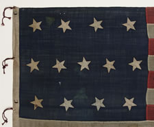 ENTIRELY HAND-SEWN, 13 STAR FLAG IN THE 4-5-4 PATTERN, PROBABLY A U.S. NAVY SMALL BOAT ENSIGN, MADE SOMETIME BETWEEN 1850 AND THE OPENING YEARS OF THE CIVIL WAR (1861-63)