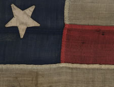 ENTIRELY HAND-SEWN, 13 STAR FLAG IN THE 4-5-4 PATTERN, PROBABLY A U.S. NAVY SMALL BOAT ENSIGN, MADE SOMETIME BETWEEN 1850 AND THE OPENING YEARS OF THE CIVIL WAR (1861-63)