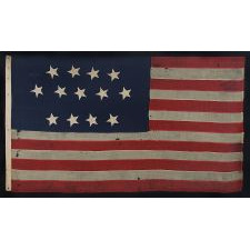 ENTIRELY HAND-SEWN, 13 STAR, U.S. NAVY SMALL BOAT ENSIGN WITH A 4-5-4 CONFIGURATION OF SINGLE-APPLIQUÉD STARS, MADE SOMETIME BETWEEN 1850 AND THE OPENING YEARS OF THE CIVIL WAR (1854-64)