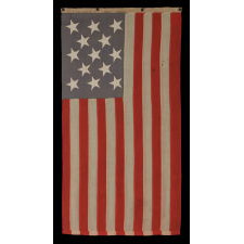 ENTIRELY HAND-SEWN, 13 STAR, U.S. NAVY SMALL BOAT ENSIGN WITH A DUSTY BLUE CANTON, SIGNED AND DATED, 1889