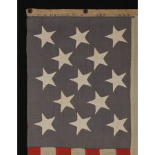 ENTIRELY HAND-SEWN, 13 STAR, U.S. NAVY SMALL BOAT ENSIGN WITH A DUSTY BLUE CANTON, SIGNED AND DATED, 1889