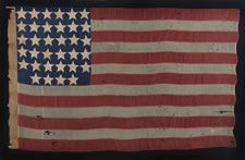 ENTIRELY HAND-SEWN 34 STAR FLAG OF THE CIVIL WAR PERIOD WITH A GREAT EARLY APPEARANCE, A WIDE LINEN SLEEVE, AND A VERY UNUSUAL ARRANGEMENT OF UNCOMMONLY LARGE STARS, 1861-63