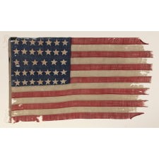 ENTIRELY HAND-SEWN 34 STAR FLAG OF THE CIVIL WAR PERIOD, WITH HAND-SEWN, SINGLE-APPLIQUED STARS AND ENDEARING WEAR FROM LONG-TERM USE, REFLECTS KANSAS STATEHOOD, 1861-1863