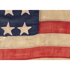 ENTIRELY HAND-SEWN 34 STAR FLAG OF THE CIVIL WAR PERIOD, WITH HAND-SEWN, SINGLE-APPLIQUED STARS AND ENDEARING WEAR FROM LONG-TERM USE, REFLECTS KANSAS STATEHOOD, 1861-1863