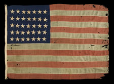 ENTIRELY HAND-SEWN FLAG OF THE CIVIL WAR PERIOD, WITH 35 STARS, 1863-65, WEST VIRGINIA STATEHOOD, IN A SMALL SCALE FOR THE PERIOD AND HIGHLY UNUSUAL WITH DIFFERENT SIZES OF STARS ON ITS OPPOSING SIDES