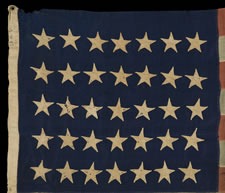 ENTIRELY HAND-SEWN FLAG OF THE CIVIL WAR PERIOD, WITH 35 STARS, 1863-65, WEST VIRGINIA STATEHOOD, IN A SMALL SCALE FOR THE PERIOD AND HIGHLY UNUSUAL WITH DIFFERENT SIZES OF STARS ON ITS OPPOSING SIDES