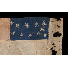 EXCEPTIONAL CONFEDERATE 1ST NATIONAL PATTERN BIBLE FLAG WITH A CRESCENT FORMATION OF 11 STARS, 2 OF WHICH APPEAR TO HAVE BEEN SUBSEQUENTLY ADDED AS MORE STATES SECEDED FROM THE UNION; MADE ca MARCH-MAY, 1861, UPDATED BETWEEN THEN AND OCTOBER; FOUND AMONG A COLLECTION OF LETTERS WRITTEN BY TWO NEW ENGLAND SOLDIERS, PROBABLE UNION CAPTURE