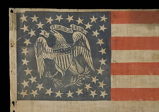 EXTREMELY RARE PARADE FLAG WITH 36 STARS AND AN EAGLE IN THE CANTON, AN IMPORTANT, UNDOCUMENTED EXAMPLE AND THE ONLY ONE OF ITS KIND KNOWN TO EXIST IN THIS STAR COUNT