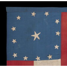 CIVIL WAR PERIOD CONFEDERATE FLAG IN THE FIRST NATIONAL PATTERN (a.k.a., STARS & BARS), HOMEMADE & ENTIRELY HAND-SEWN, WITH 13 STARS ARRANGED IN A WIDELY DISPURSED WREAT OF 12, WITH A LARGE, STARFISH-SHAPED CENTER STAR, ON A CANTON OF BLUE COTTON CHINTZ, DEC. 1861 – JUNE 1863