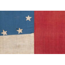 CIVIL WAR PERIOD CONFEDERATE FLAG IN THE FIRST NATIONAL PATTERN (a.k.a., STARS & BARS), HOMEMADE & ENTIRELY HAND-SEWN, WITH 13 STARS ARRANGED IN A WIDELY DISPURSED WREAT OF 12, WITH A LARGE, STARFISH-SHAPED CENTER STAR, ON A CANTON OF BLUE COTTON CHINTZ, DEC. 1861 – JUNE 1863