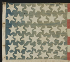 FROM THE MASTAI COLLECTION OF ANTIQUE AMERICAN FLAGS, FEATURED ON THE INSIDE PAPERS OF THE MASTAI BOOK:  42 STARS, A HOMEMADE COTTON FLAG WITH GREAT FOLK QUALITIES, WASHINGTON STATEHOOD, 1889-1890