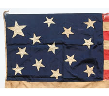 A HIGHLY UNUSUAL, ENTIRELY HAND-SEWN 13 STAR FLAG, CA 1850 - CIVIL WAR ERA (1861-65), WITH A HUGE STAR IN THE UPPER HOIST END CORNER OF A 3-2-3-2-3 CONFIGURATION