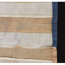 HOMEMADE FLAG WITH 13 STARS ARRANGED IN THE CIRCULAR WREATH PATTERN OFTEN ATTRIBUTED TO BETSY ROSS, WITH ENDEARING WEAR, AND WITH ITS CANTON RESTING ON THE WAR STRIPE, CA 1890-1920's