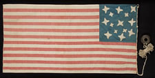 A MASTERPIECE OF FOLK ART IN EARLY FLAG-MAKING:  14 STARS AND 21 STRIPES, WHALEBONE EYELETS, A HIGHLY UNUSUAL FLAG WITH POSSIBLE VERMONT & CIVIL WAR ASSOCIATIONS