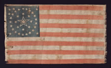 ONE-OF-A-KIND AMONG KNOWN EXAMPLES:   36 STAR PARADE FLAG WITH A MEDALLION CONFIGURATION THAT HAS A HUGE,  HALOED CENTER STAR, ONE STAR FLANKING IN EACH OF THREE CORNERS, AND A TRIO OF STARS IN ONE CORNER, CIVIL WAR ERA, NEVADA STATEHOOD, 1864-67: