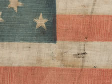 ONE-OF-A-KIND AMONG KNOWN EXAMPLES:   36 STAR PARADE FLAG WITH A MEDALLION CONFIGURATION THAT HAS A HUGE,  HALOED CENTER STAR, ONE STAR FLANKING IN EACH OF THREE CORNERS, AND A TRIO OF STARS IN ONE CORNER, CIVIL WAR ERA, NEVADA STATEHOOD, 1864-67: