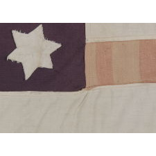 PAIR OF LIBERATION FLAGS, MADE IN FRANCE TO CELEBRATE THE ARRIVAL OF U.S. AND BRITISH TROOPS FOLLOWING LIBERATION FROM THE NAZIS DURING WWII, NOTE THE STAR OF DAVID-SHAPED PROFILES ON THE AMERICAN EXAMPLE AND THE USE OF THE SAME CANDY-STRIPED FABRIC IN BOTH FLAGS, CA 1944