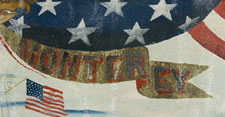 PATRIOTIC BANNER DEPICTING THE U.S.S. MONTEREY, FRAMED BY BILLOWING FLAGS, A SPREADWING EAGLE, AND SALIOR-BRAIDED ROPE FRINGE, ca 1898-99